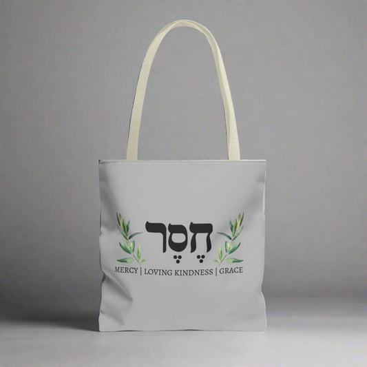 A canvas tote with Hesed word in Hebrew writing
