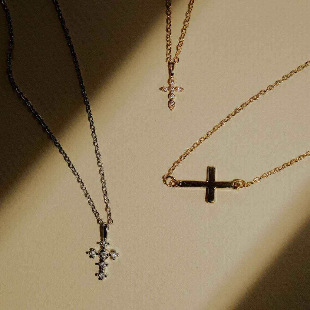 Dainty cross necklace in gold and silver, simple and elegant design.