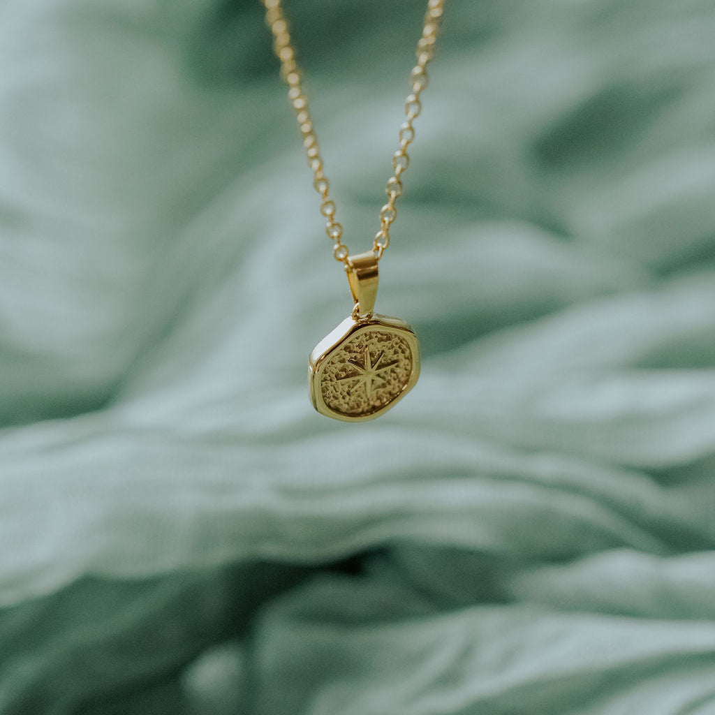 Guiding Star necklace shown on a model or display stand, capturing its shine and symbolic reminder to look to Christ.